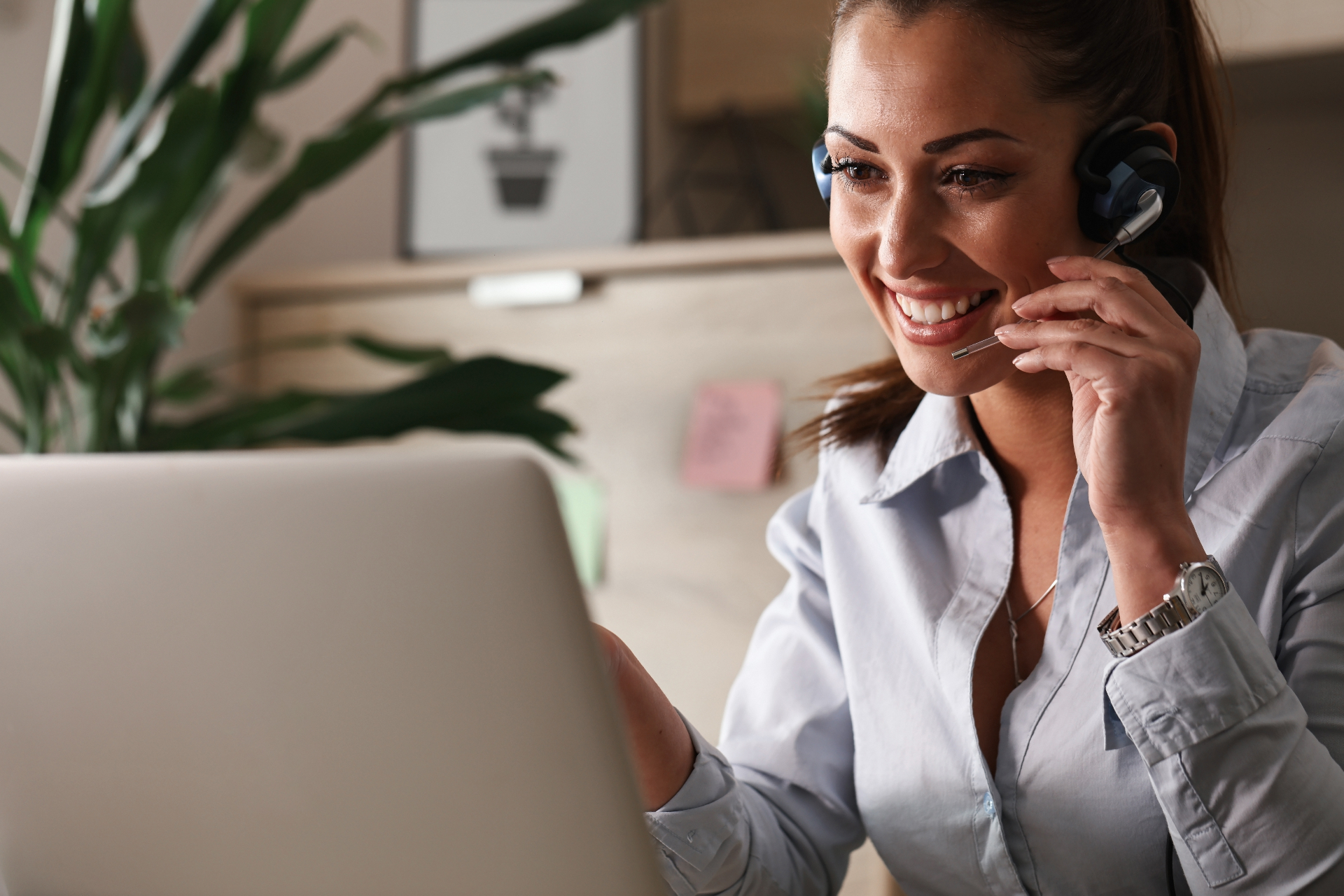 Friendly reception team member assisting a patient by phone